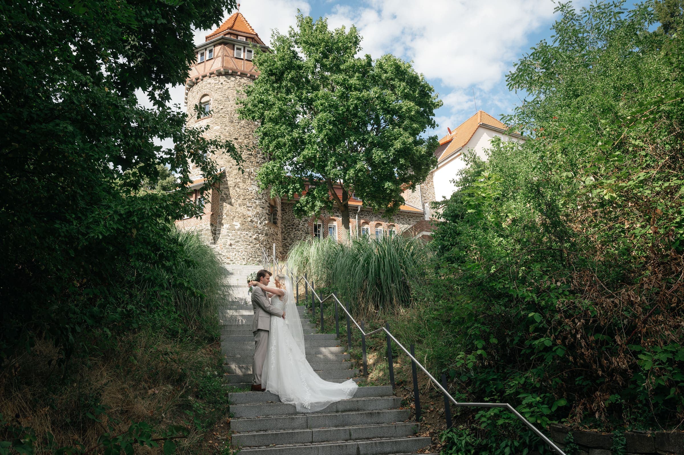 Brautpaar auf der Treppe unterhalb des Turms der Villa Meßmer